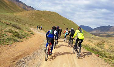 Mountain bikers group racing in desert