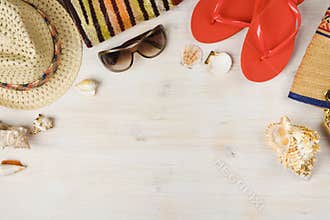 Top view of summer beach accessories on wooden background