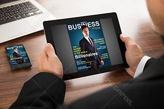 Businessman reading online magazine