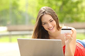 Shopper girl buying online with a laptop and credit card