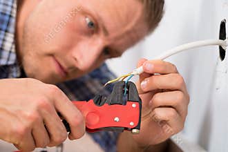Close-up of electrician stripping wires