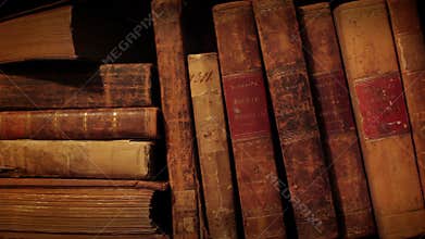 Bookshelf in library. Old thorn books.