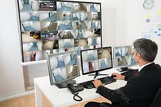 Man in control room looking at cctv footage
