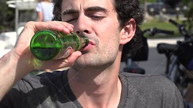 Man Drinking Bottle of Beer