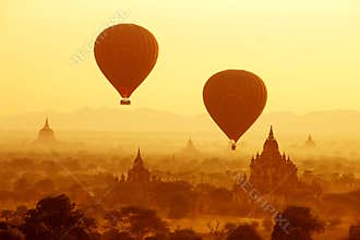Air balloons over Buddhist temples at sunrise