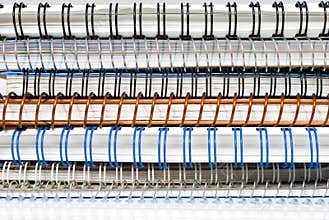 Stack of spiral paper notebooks with coil binding