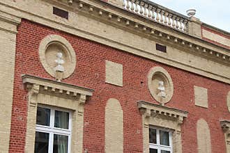 Feminine busts decorate the facade of a brick house situated in Deauville (France)
