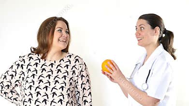 Doctor advising a fat woman to eat healthy