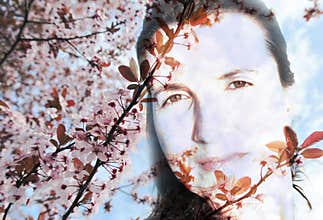 Double exposure image of a young woman and spring flowers