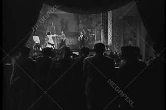 Rear view of audience watching performance in theater