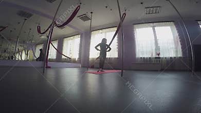 Child doing warm-up ankle exercises at dance class