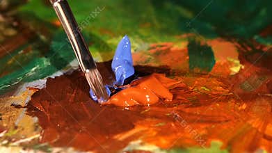Painter mix brown, blue and orange colors oil