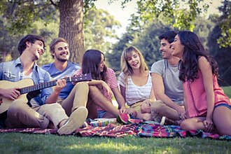 happy friends in a park having a picnic