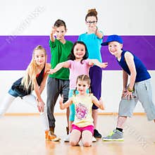Kids train Zumba fitness in dancing school