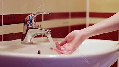 Water flows tap man fingers