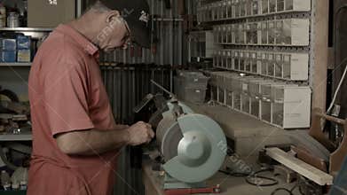 Man working indoors in hobby shed or workshop with carpentry power tools