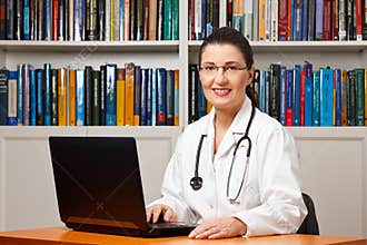 Friendly smiling doctor laptop computer