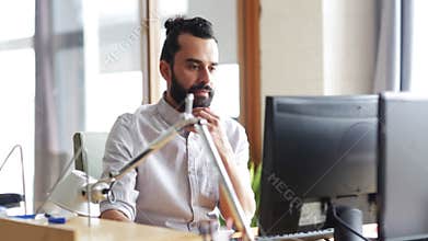 Happy creative team with computers in office