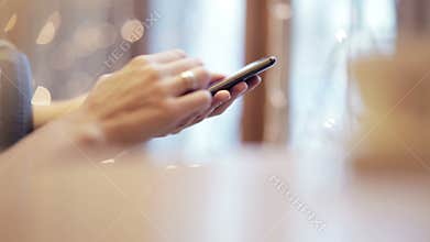 Woman hands texting, using smartphone in cafe.
