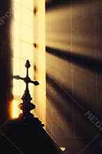 Cross in church with sun beams