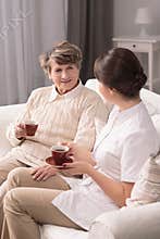 Carer assisting elderly woman