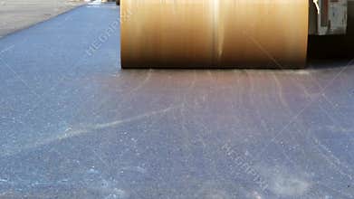 Road rollers leveling fresh asphalt pavement