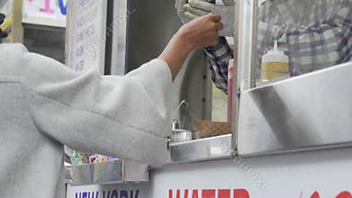 Views of people buying from an NYC food vendor