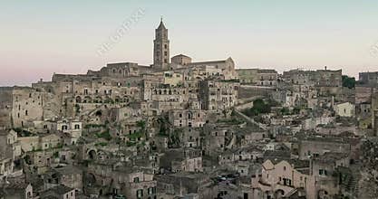 Panoramic view of typical stones and church of Matera under sunset sky