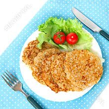 A potato pancakes with lettuce and tomatos