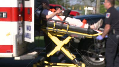 Woman moved by stretcher into ambulance