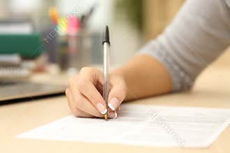Woman hand writing or signing in a document