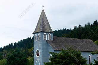 Building is small provincial Christian church with tower and cro