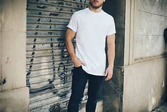 Bearded young man wearing white blank t-shirt and