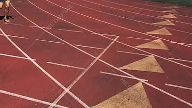 Athlete Sprinting in Slow Motion on Running Track