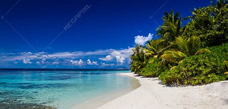 Maldives beach panorama, blue sky, coral reef
