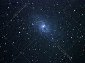 Universe stars and spiral galaxy M33 over telescope