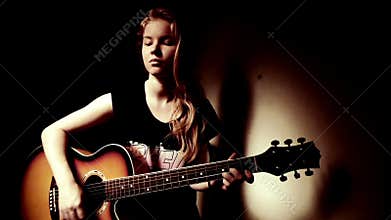 Teen Girl Playing Guitar At Home