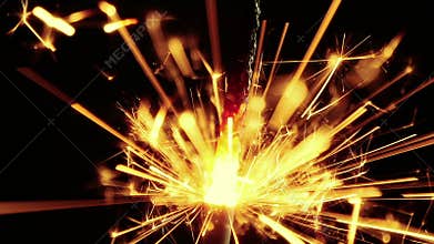 Close-up of firework sparkler burning on black background, congratulation greeting party happy new year, christmas