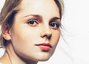 Studio beauty. Portrait of smiling young and happy woman with freckles. Isolated on white.