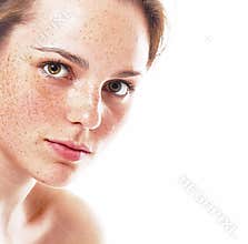 Studio beauty. Portrait of smiling young and happy woman with freckles. Isolated on white.