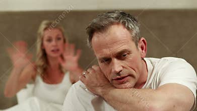 Mature couple arguing in bedroom