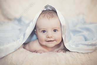 Baby under blanket
