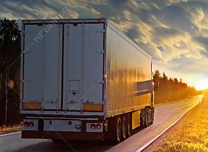 White truck on rural road in evening