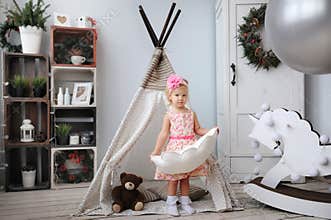 The little girl plays in the nursery.