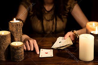 Female psychic is telling the future with cards, concept tarot a
