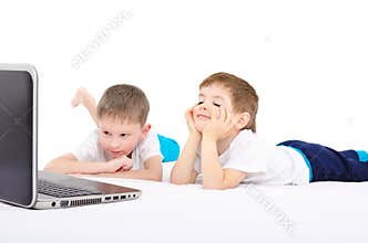 Two boys looking on laptop