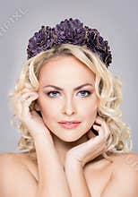 Close-up of young, sensual woman wearing purple flower alike coronet