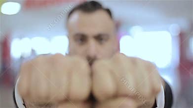 Man makes his fists, showing by his power