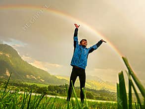 Touch a rainbow, Joyful Hiker Reaching for the Rainbow in Lush Valley, Slovakia