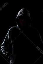 Faceless guy in hoodie in the darkness